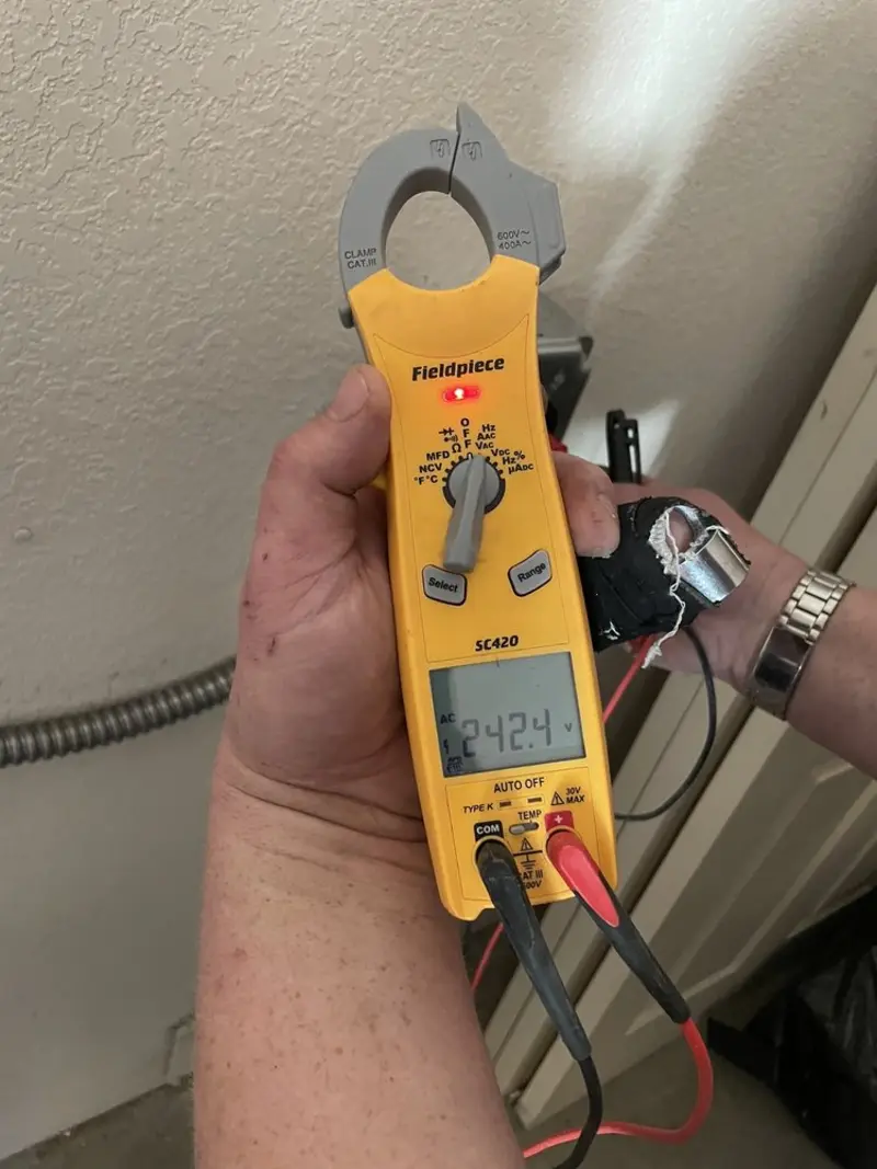 Voltage testing with clamp meter during Ceiling Fan Installation in Burlington
